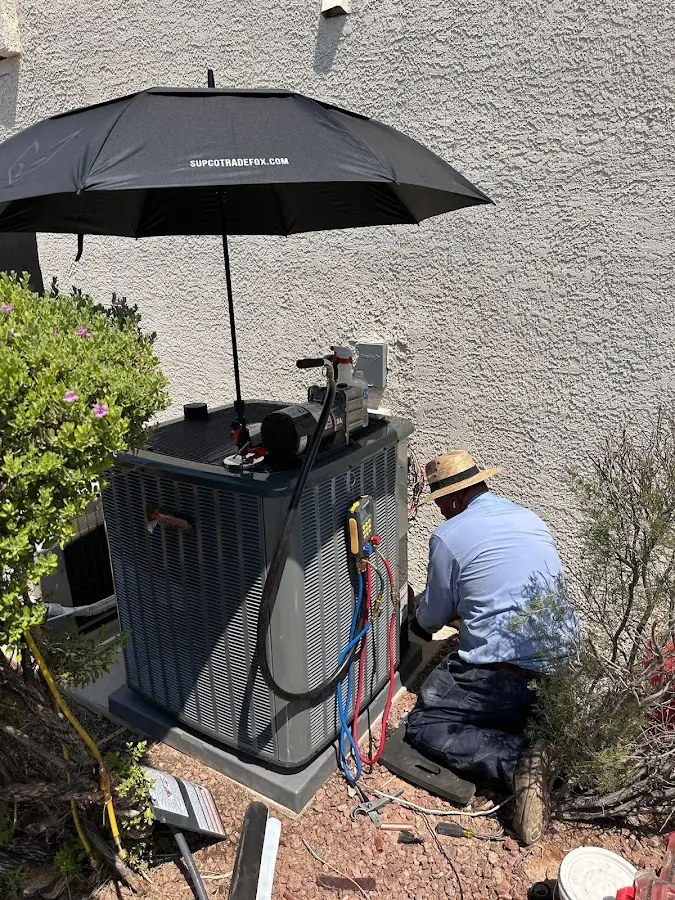 HVAC technician performing outdoor AC maintenance in Helena Valley West Central